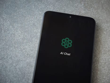 Lod, Israel - July 16,2023: Chat AI app launch screen on smartphone on ceramic stone background. Top view flat lay with copy space.