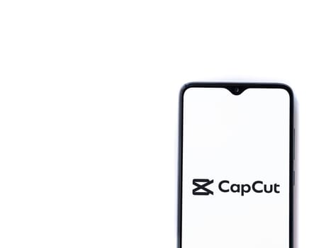 Lod, Israel - July 16,2023: CapCut app launch screen on smartphone on white background.. Top view flat lay with copy space.