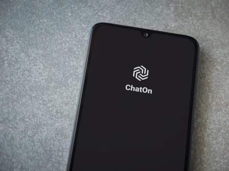 Lod, Israel - July 16,2023: ChatOn app launch screen on smartphone on ceramic stone background. Top view flat lay with copy space.