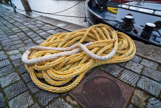 piece of rope lying on the quay next to a boat