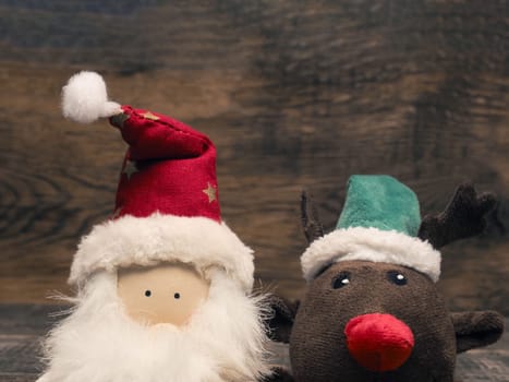 Santa and reindeer  on a wooden background with space for text, Christmas or seasonal greetings card backdrop