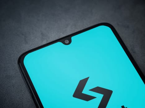 Lod, Israel - July 16,2023: Bitget app launch screen on smartphone on dark marble stone background. Top view flat lay with copy space.