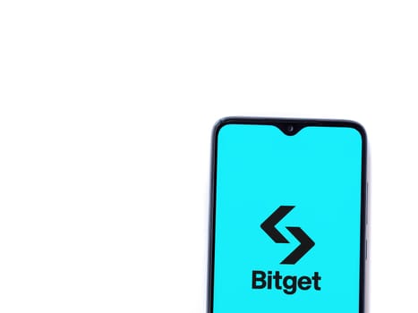 Lod, Israel - July 16,2023: Bitget app launch screen on smartphone on white background. Top view flat lay with copy space.
