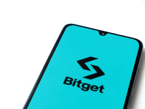 Lod, Israel - July 16,2023: Bitget app launch screen on smartphone on white background. Top view flat lay with copy space.