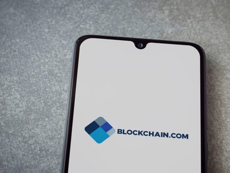 Lod, Israel - July 16,2023: Blockchain.com app launch screen on smartphone on ceramic stone background. Top view flat lay with copy space.