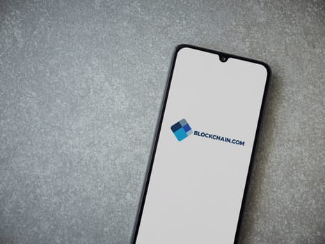 Lod, Israel - July 16,2023: Blockchain.com app launch screen on smartphone on ceramic stone background. Top view flat lay with copy space.