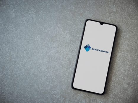 Lod, Israel - July 16,2023: Blockchain.com app launch screen on smartphone on ceramic stone background. Top view flat lay with copy space.