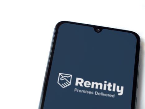 Lod, Israel - July 16,2023: Remitly app launch screen on smartphone on white background. Top view flat lay with copy space.