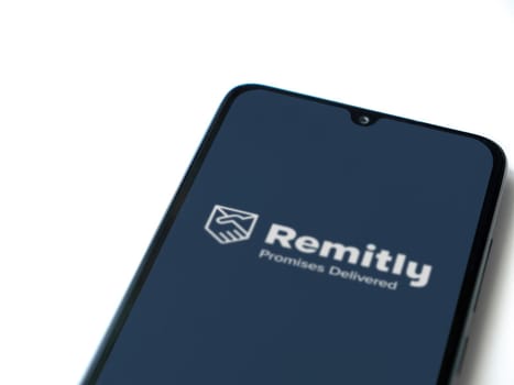 Lod, Israel - July 16,2023: Remitly app launch screen on smartphone on white background. Top view flat lay with copy space.