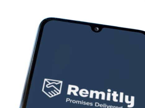 Lod, Israel - July 16,2023: Remitly app launch screen on smartphone on white background. Top view flat lay with copy space.