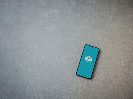 Lod, Israel - July 16,2023: pCloud app launch screen on smartphone on ceramic stone background. Top view flat lay with copy space.
