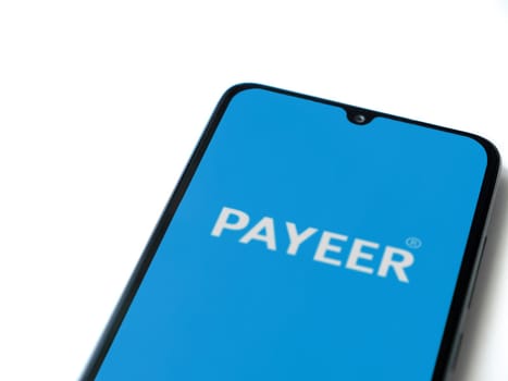 Lod, Israel - July 16,2023: PAYEER app launch screen on smartphone on white background. Top view flat lay with copy space.
