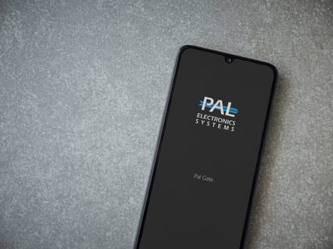 Lod, Israel - July 16,2023: PalGate app launch screen on smartphone on ceramic stone background. Top view flat lay with copy space.