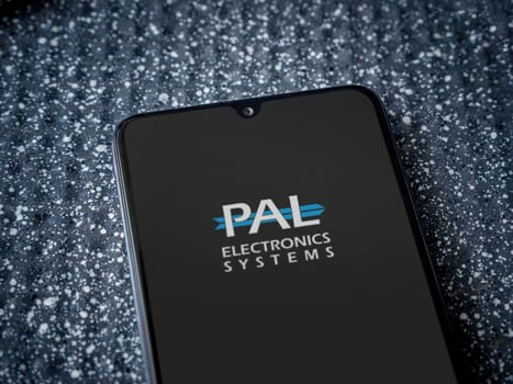 Lod, Israel - July 16,2023: PalGate app launch screen on smartphone on metallic background. Close up top view flat lay.