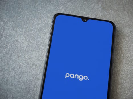 Lod, Israel - July 16,2023: Pango app launch screen on smartphone on ceramic stone background. Top view flat lay with copy space.