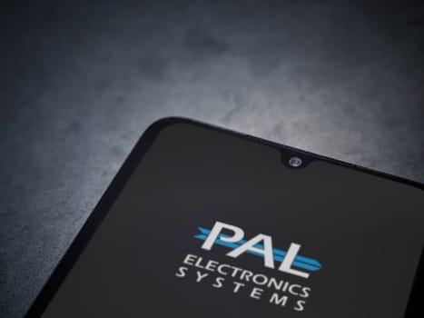 Lod, Israel - July 16,2023: PalGate app launch screen on smartphone on dark marble stone background. Top view flat lay with copy space.