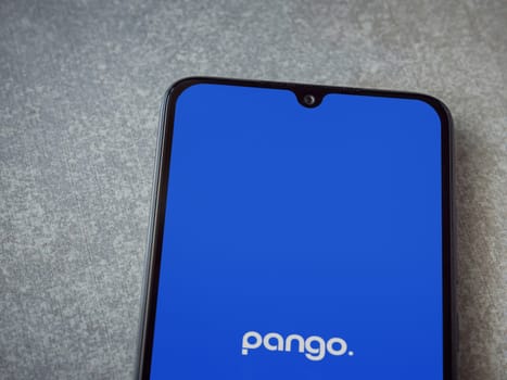 Lod, Israel - July 16,2023: Pango app launch screen on smartphone on ceramic stone background. Top view flat lay with copy space.