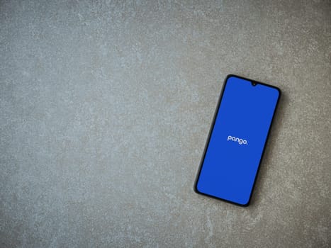 Lod, Israel - July 16,2023: Pango app launch screen on smartphone on ceramic stone background. Top view flat lay with copy space.