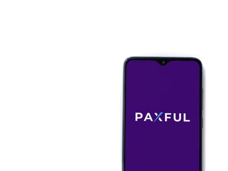 Lod, Israel - July 16,2023: Paxful app launch screen on smartphone on white background. Top view flat lay with copy space.