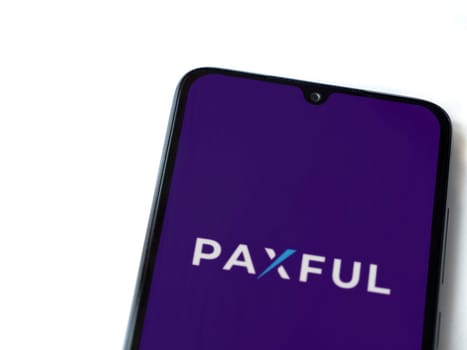 Lod, Israel - July 16,2023: Paxful app launch screen on smartphone on white background. Top view flat lay with copy space.