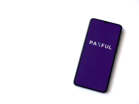 Lod, Israel - July 16,2023: Paxful app launch screen on smartphone on white background. Top view flat lay with copy space.