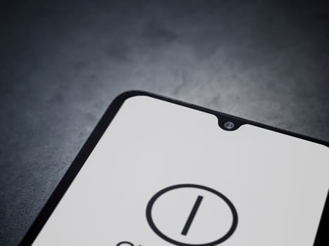 Lod, Israel - July 16,2023: One Zero app launch screen on smartphone on dark marble stone background. Top view flat lay with copy space.