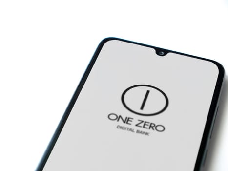 Lod, Israel - July 16,2023: One Zero app launch screen on smartphone on white background. Top view flat lay with copy space.