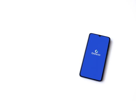 Lod, Israel - July 16,2023: Gate.io app launch screen on smartphone on white background. Top view flat lay with copy space.