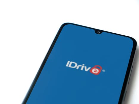 Lod, Israel - July 16,2023: IDrive Online Backup app launch screen on smartphone on white background. Top view flat lay with copy space.