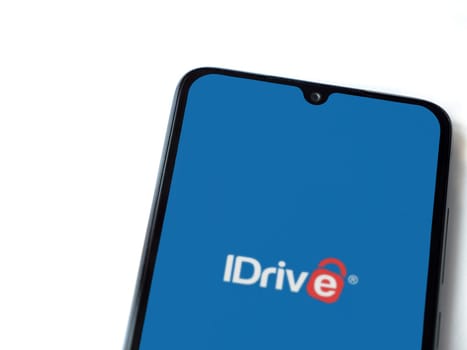 Lod, Israel - July 16,2023: IDrive Online Backup app launch screen on smartphone on white background. Top view flat lay with copy space.