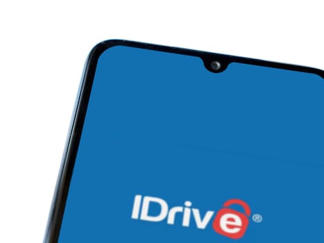 Lod, Israel - July 16,2023: IDrive Online Backup app launch screen on smartphone on white background. Top view flat lay with copy space.