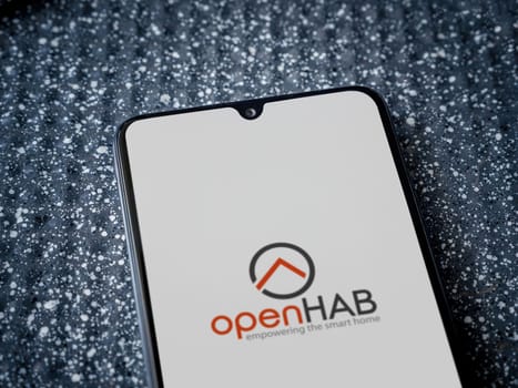 Lod, Israel - July 16,2023: openHAB app launch screen on smartphone on metallic background. Close up top view flat lay.