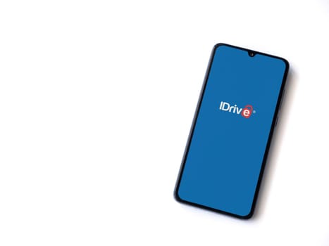 Lod, Israel - July 16,2023: IDrive Online Backup app launch screen on smartphone on white background. Top view flat lay with copy space.