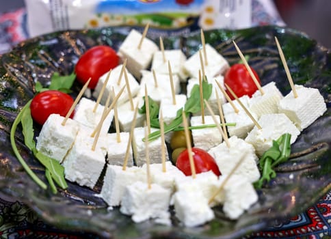 appetizers of white cheese and cherry tomatoes