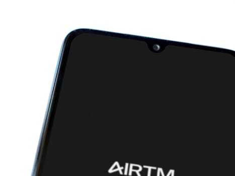 Lod, Israel - July 16,2023: AirTM app launch screen on smartphone on white background. Top view flat lay with copy space.