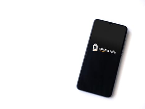 Lod, Israel - July 16,2023: Amazon Seller app launch screen on smartphone on white background. Top view flat lay with copy space.