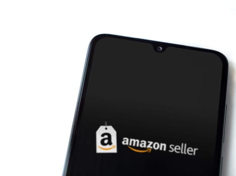 Lod, Israel - July 16,2023: Amazon Seller app launch screen on smartphone on white background. Top view flat lay with copy space.