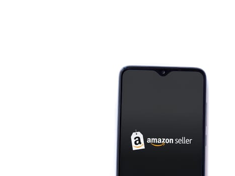 Lod, Israel - July 16,2023: Amazon Seller app launch screen on smartphone on white background. Top view flat lay with copy space.