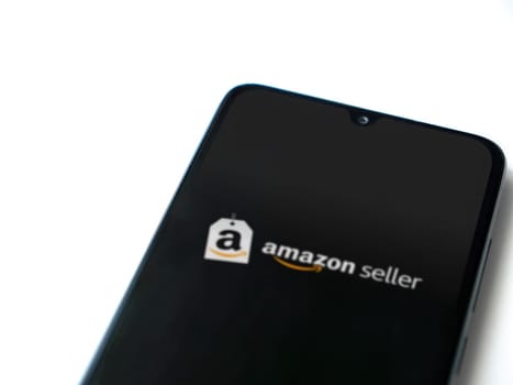 Lod, Israel - July 16,2023: Amazon Seller app launch screen on smartphone on white background. Top view flat lay with copy space.