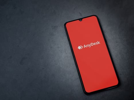Lod, Israel - July 16,2023: Anydesk app launch screen on smartphone on dark marble stone background. Top view flat lay with copy space.