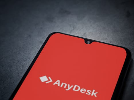 Lod, Israel - July 16,2023: Anydesk app launch screen on smartphone on dark marble stone background. Top view flat lay with copy space.