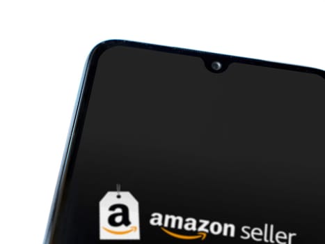 Lod, Israel - July 16,2023: Amazon Seller app launch screen on smartphone on white background. Top view flat lay with copy space.