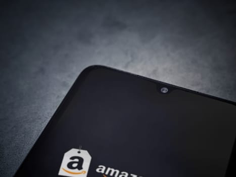 Lod, Israel - July 16,2023: Amazon Seller app launch screen on smartphone on dark marble stone background. Top view flat lay with copy space.