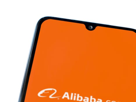 Lod, Israel - July 16,2023: Alibaba.com app launch screen on smartphone on white background. Top view flat lay with copy space.
