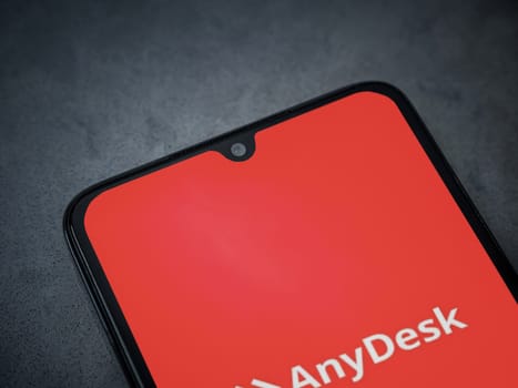 Lod, Israel - July 16,2023: Anydesk app launch screen on smartphone on dark marble stone background. Top view flat lay with copy space.