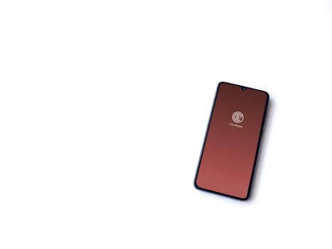 Lod, Israel - July 16,2023: CoinWallet app launch screen on smartphone on white background. Top view flat lay with copy space.