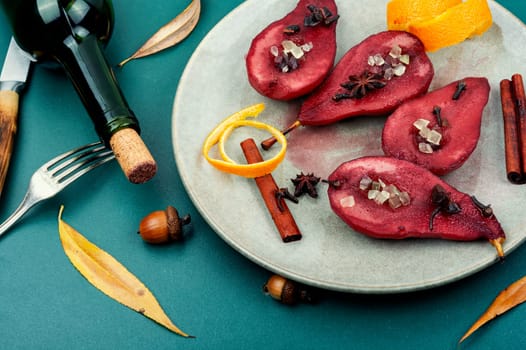 Autumn spicy pears in wine, sweet poached pears in red wine. Healthy sweet dessert.