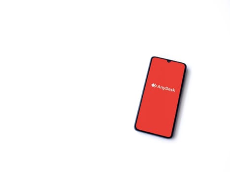 Lod, Israel - July 16,2023: Anydesk app launch screen on smartphone on white background. Top view flat lay with copy space.