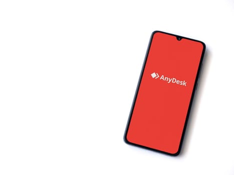 Lod, Israel - July 16,2023: Anydesk app launch screen on smartphone on white background. Top view flat lay with copy space.