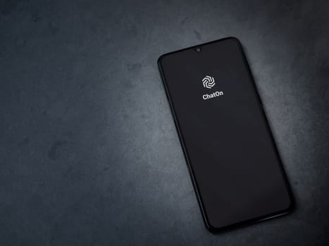 Lod, Israel - July 16,2023: ChatOn app launch screen on smartphone on dark marble stone background. Top view flat lay with copy space.